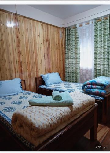 Ένα ή περισσότερα κρεβάτια σε δωμάτιο στο Tigerhill Homestay