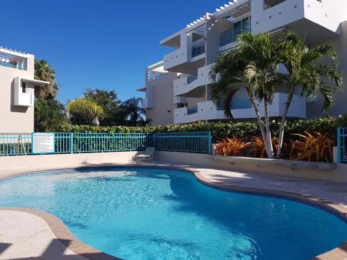 a swimming pool in front of a apartment building at Puerto Azul Family Getaway Pool Beach 5 min in Boqueron