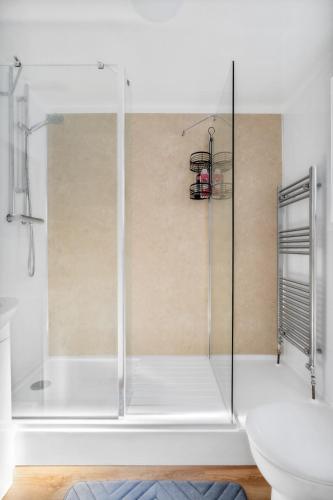a shower with a glass door in a bathroom at The Old Laundry - FREE Parking - Town Centre in Worthing
