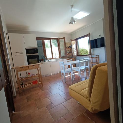 a living room with a couch and a table and chairs at Macchie Basse Guest House - Agriturismo in Pescia Fiorentina