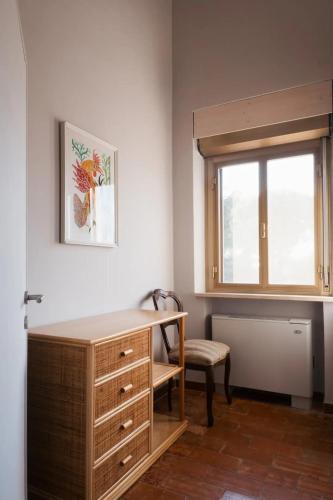 a room with a desk and a chair and a window at Macchie Basse Guest House - Agriturismo in Pescia Fiorentina