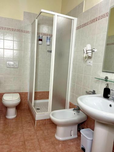 a bathroom with a shower and a toilet and a sink at La Locanda Del Castello in Ocre