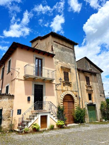 an old building with a balcony on the side of it at La Locanda Del Castello in Ocre