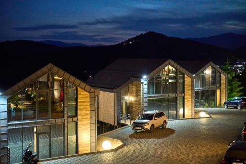 a car parked in front of a building at night at Villas Fomich in Bukovel