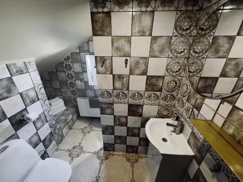 a bathroom with a sink and a toilet at Very Bad Hootel in Kaunas
