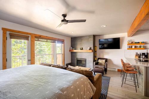 a bedroom with a bed and a fireplace at Der Steiermark Unit 108 - Cozy King Studio Off Main St & Peak 9 Base w AC, Balcony, Shared Hot Tub & Free Parking - No Fireplace in Breckenridge