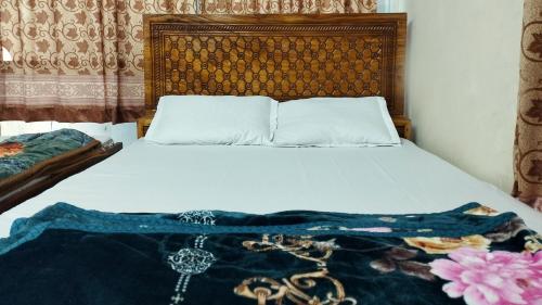 Ένα ή περισσότερα κρεβάτια σε δωμάτιο στο New Hotel Labbaik