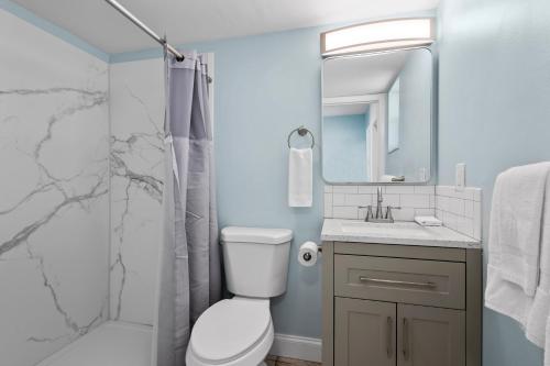 a bathroom with a toilet sink and a shower at Ocean View Hotel Room with Balcony- King Bed #23 in Fort Pierce