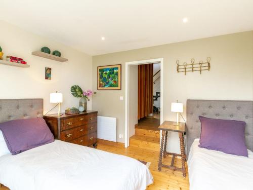 a bedroom with two beds and a table with two lamps at Holiday Home La Bellevue de Pen Ar Rhun by Interhome in Locquirec