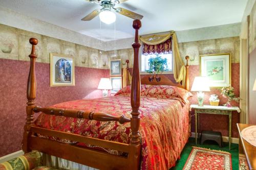 a bedroom with a large bed with a red bedspread at Large and Private Guest House Apt with Patio and Views! in Danville