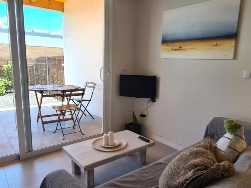 a living room with a couch and a table at Estudio SoleArte en Lajares in Lajares