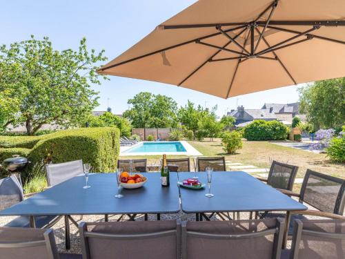 - une table avec un bol de fruits et un parasol dans l'établissement Holiday Home La maison des Frères - Villa by Interhome, à Caden