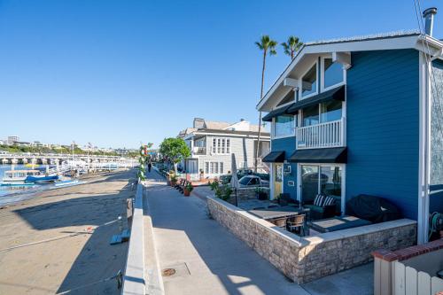 a blue building next to a beach with palm trees at 1011 N Bayfront A & B in Newport Beach