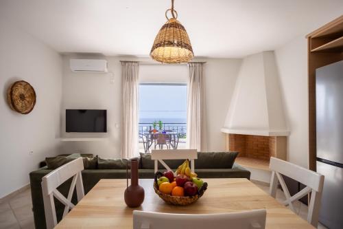 a living room with a table with a bowl of fruit at THREE GRACES filikon in Zakynthos Town