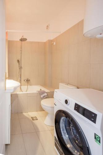 a washing machine in a bathroom with a toilet at THREE GRACES filikon in Zakynthos Town