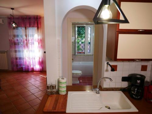 a kitchen with a sink and a bathroom at Vacanze Romane in Acilia