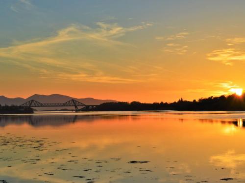 a bridge over a river at sunset at Holiday Home An Cala by Interhome in Oban