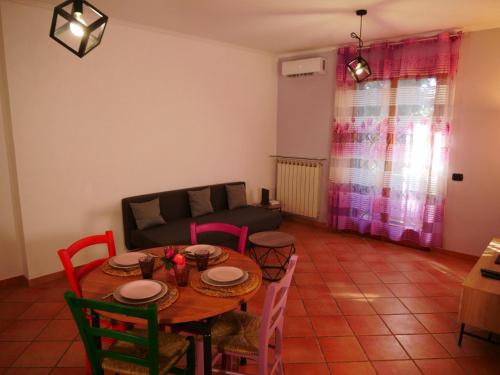 a living room with a table and chairs and a couch at Vacanze Romane in Acilia