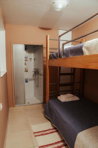a bedroom with a bunk bed and a shower at MountSea Villa in Agios Nikolaos