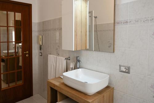 a bathroom with a white sink and a mirror at Casa Aricò in Calatabiano