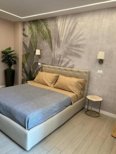 a bed in a bedroom with a wall mural at Botanic Exclusive Room in Pescara