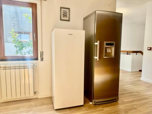 a large refrigerator in a room with a window at AOMO ART SPACE Hostel in Oeiras
