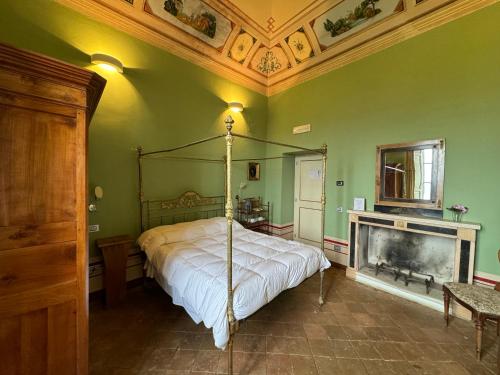 a bedroom with a canopy bed and a fireplace at Villa Dell'Annunziata in Rieti
