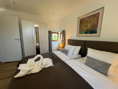 a bedroom with two beds with white towels on them at AOMO ART SPACE Hostel in Oeiras