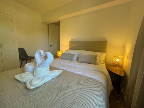 a hotel room with a bed with a baby sitting on it at AOMO ART SPACE Hostel in Oeiras