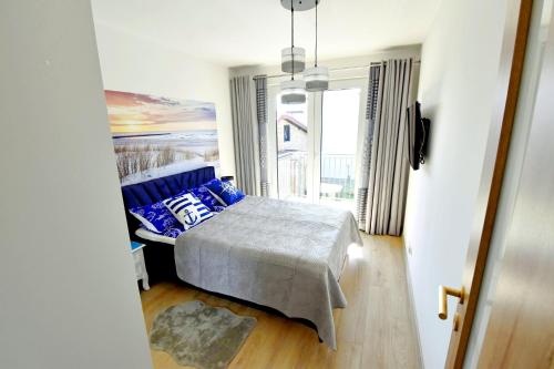 Ένα ή περισσότερα κρεβάτια σε δωμάτιο στο Apartament Muszelka 27