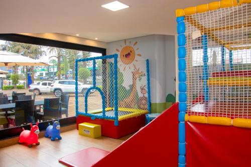 a childrens play room with a play equipment at HD Plaza Hotel in Assis