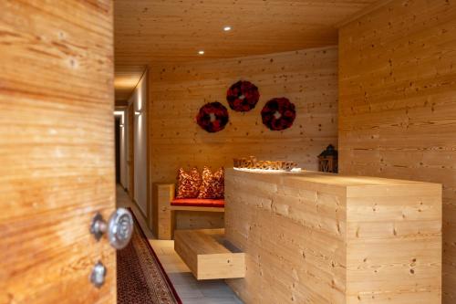 a sauna with wooden walls and a bench in a room at Ciasa Sopl&agrave; in San Cassiano