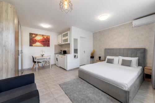 a bedroom with a bed and a desk and a kitchen at Downtown Victoria Studios By CityBookings in Bucharest