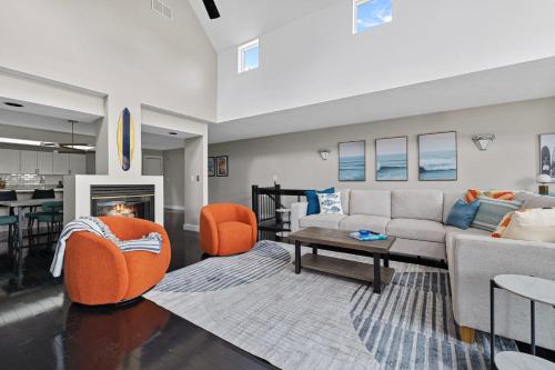 a living room with a couch and chairs and a table at Surf Loft in Saint Joseph