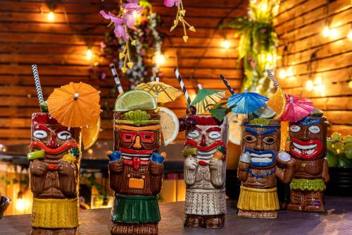 a group of wooden figurines holding umbrellas on a table at Apartament Morskie Vegas Łeba in Łeba