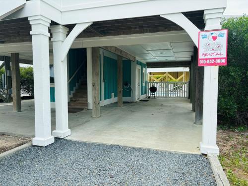 a building with a sign on the side of it at 2ice As Nice in Holden Beach