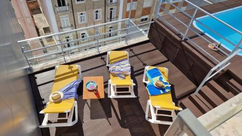 an overhead view of a balcony with chairs and tables at Hotel 3K Madrid in Lisbon
