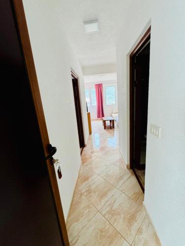 a hallway with a door leading to a living room at Vila Relax in Dobra Voda