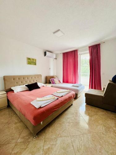 a bedroom with a large bed and a window at Vila Relax in Dobra Voda