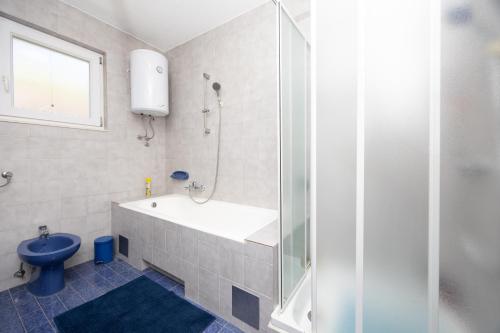 a bathroom with a shower and a sink and a toilet at Apartment Hubi in Klis
