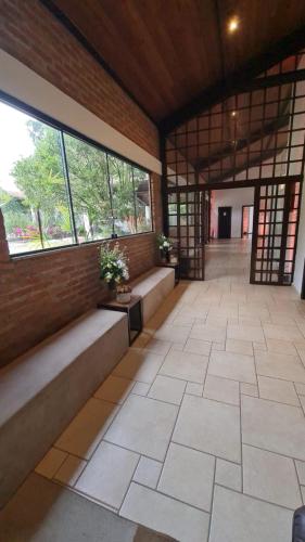 a room with benches and windows in a building at Casa Pôr Do Sol Cantareira in Mairiporã