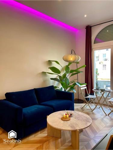 a living room with a blue couch and a table at Luxurious Apartment - Seaside - Spa Bath - WiFi - AC in Nice