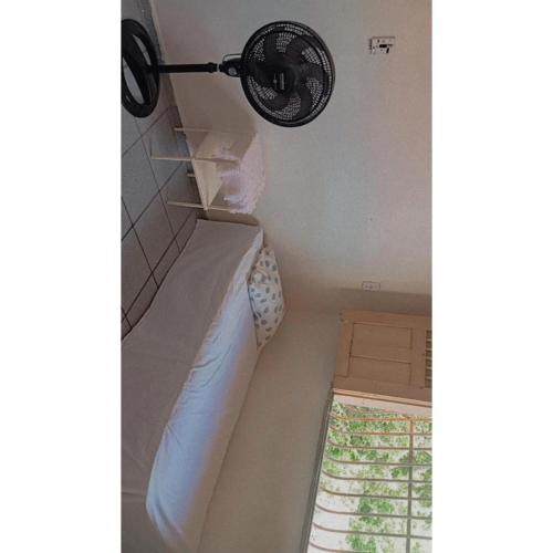 a room with a bed and a lamp on the wall at Hostel Teresina in Teresina