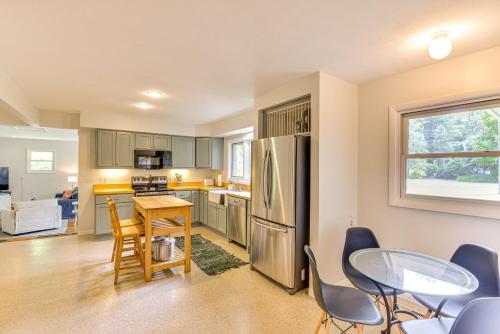 a kitchen with a table and chairs and a refrigerator at Charming Union Pier Home with Deck Half-Mi to Beach in Union Pier