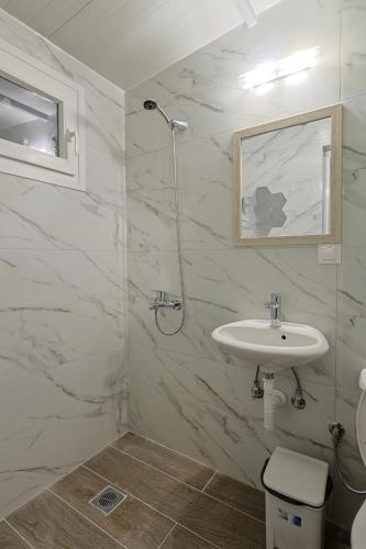 a bathroom with a sink and a shower at Zeusplace Alexandra's Pool Villa Katerini in Katerini