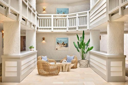 a living room with wicker chairs and a table at Omni Hilton Head Oceanfront Resort in Hilton Head Island