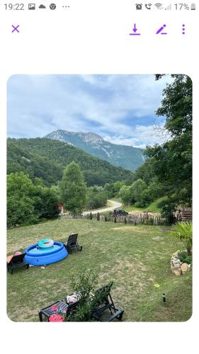 a view of a field with a tent and a mountain at VILA Ade in Padeş