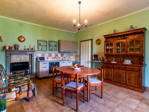 a kitchen with a table and chairs in a room at Apartment Angela by Interhome in Dongo