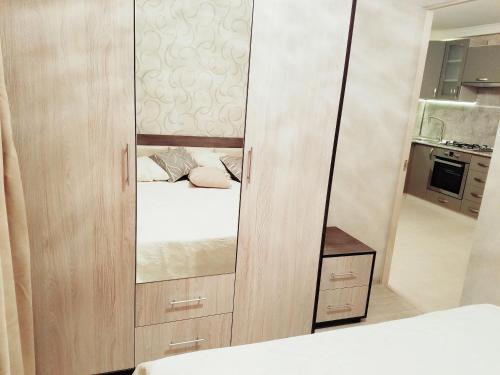 a small bedroom with a mirror and a bed at Beautiful apartment for good guests in Yerevan