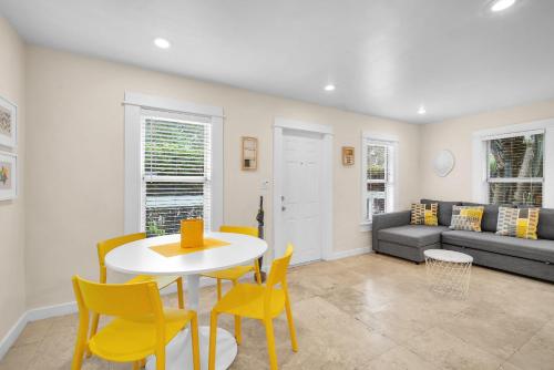 a living room with a table and chairs and a couch at Renovated Grove Bungalow -near Coconut Grove in Miami